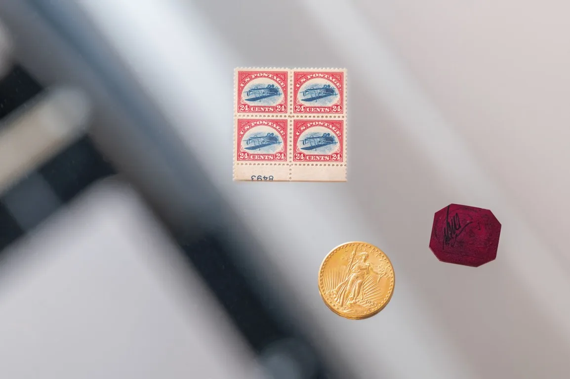 Clockwise from center: the Inverted Jenny Plate Block, the British Guiana One-Cent Black on Magenta, and the 1933 Double Eagle. Image by Julian Cassady Photography. Credit: AuctionDaily/Sotheby’s